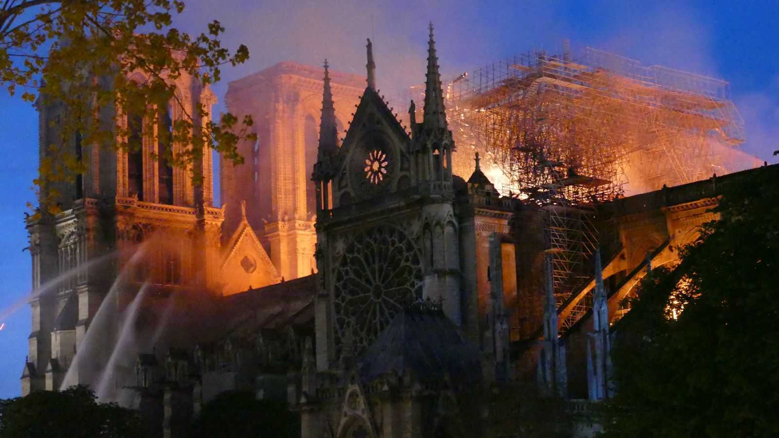 Smoke and flames rise from Notre-Dame Cathedral on April 15, 2019 in Paris, France. A fire broke out on Monday afternoon and quickly spread across the building, collapsing the spire. The cause is yet unknown but officials said it was possibly linked to ongoing renovation work.//HOUPLINERENARD_08180001/1904160824/Credit:HOUPLINE RENARD/SIPA/1904160825