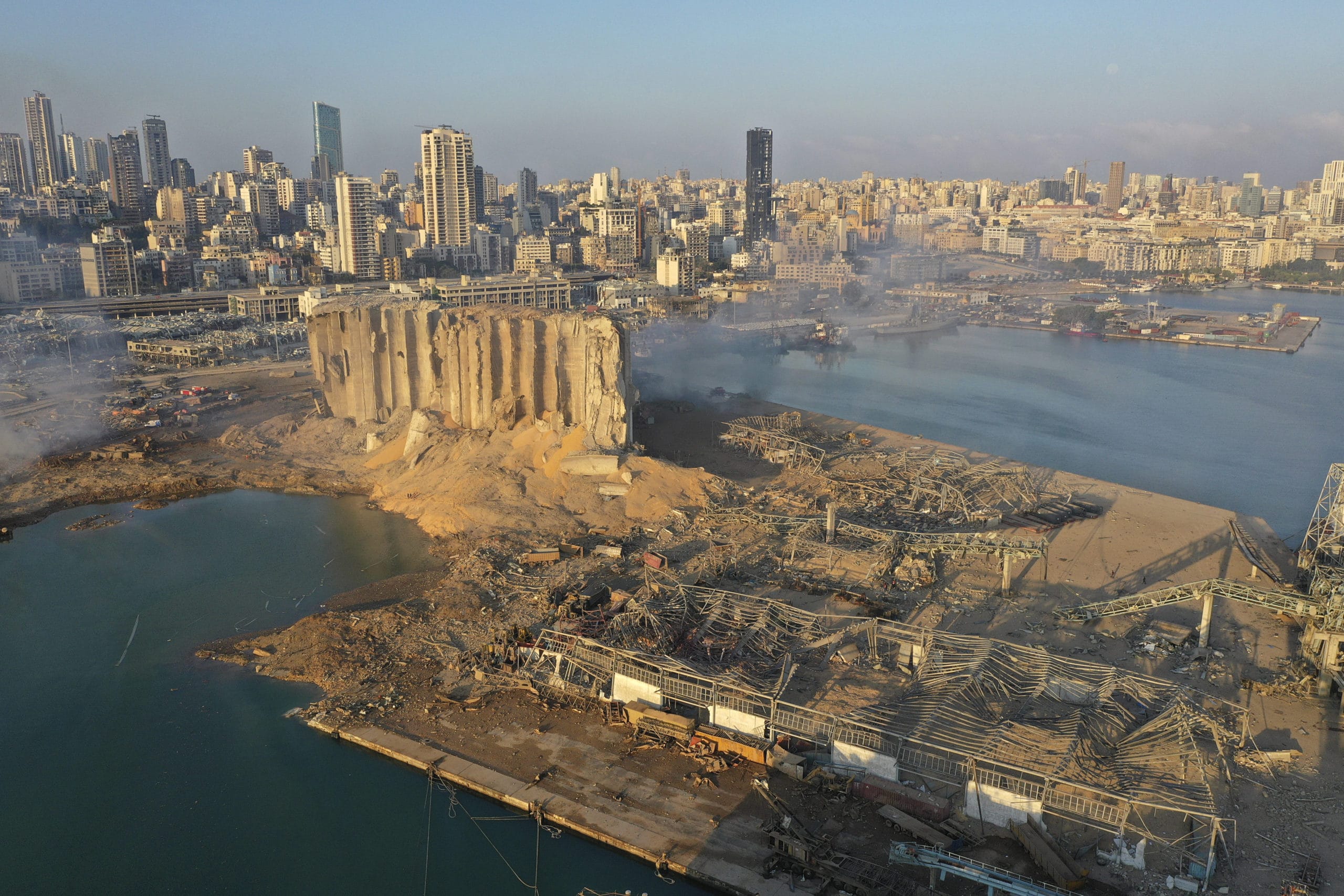 A drone picture shows the scene of an explosion that hit the seaport of Beirut, Lebanon, Wednesday, Aug. 5, 2020. A massive explosion rocked Beirut on Tuesday, flattening much of the city's port, damaging buildings across the capital and sending a giant mushroom cloud into the sky. (AP Photo/Hussein Malla)/XHM105/20218168536265/DRONE PICTURE/2008050643