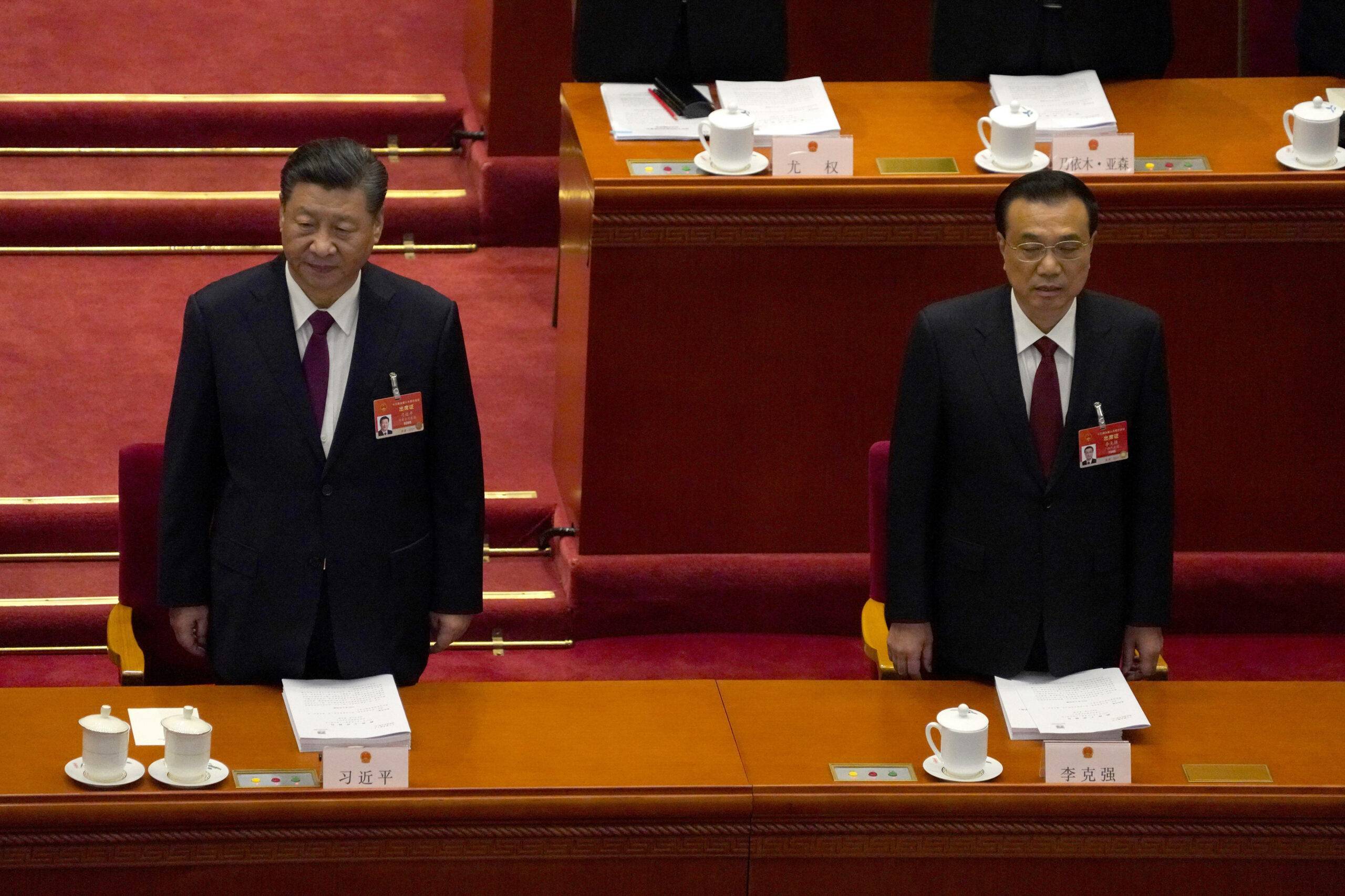 Chinese President Xi Jinping, left, and Premier Li Keqiang stand as they arrive for the opening session of China's National People's Congress (NPC) at the Great Hall of the People in Beijing, Friday, March 5, 2021. (AP Photo/Andy Wong)/XBEJ102/21064078158691//2103050313