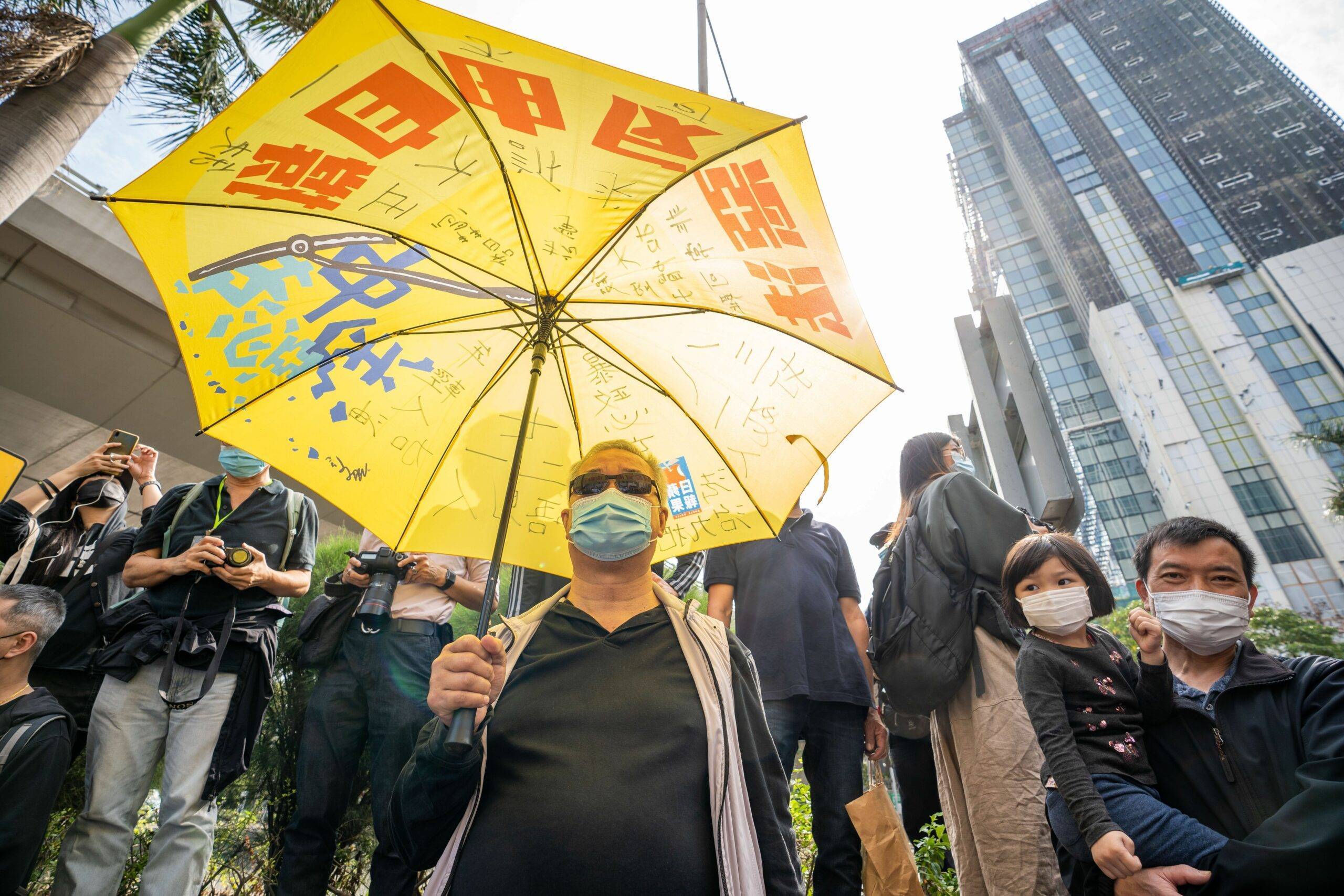 A Pro-democracy activist holds a yellow umbrella in support of arrested activists outside the West Kowloon Court.
47 pro-democracy activists charged with conspiracy to subvert state powers under the National Security Law attend their first court hearing as hundreds of their supporters comes to show their support outside the court building. - Geovien So / SOPA Images//SOPAIMAGES_sopa017012/2103011007