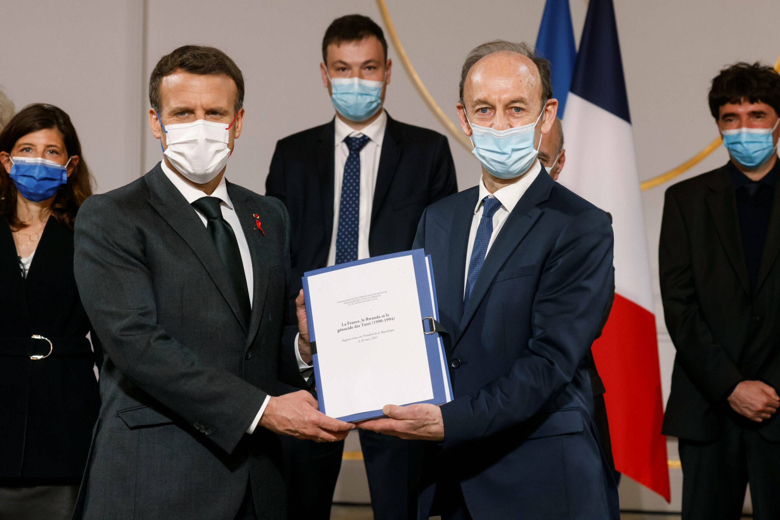 Historian and Commission chief on the France's role in 1994's Rwandan genocide, Vincent Duclert, right, gives a report to French President Emmanuel Macron, at the Elysee Palace, in Paris, Friday, March 26, 2021. The findings of a commission that has spent two years uncovering France's role in 1994's Rwandan genocide is to be made public Friday. (Ludovic Marin, Pool photo via AP)/XTC106/21085598125272/12345678/2103261750