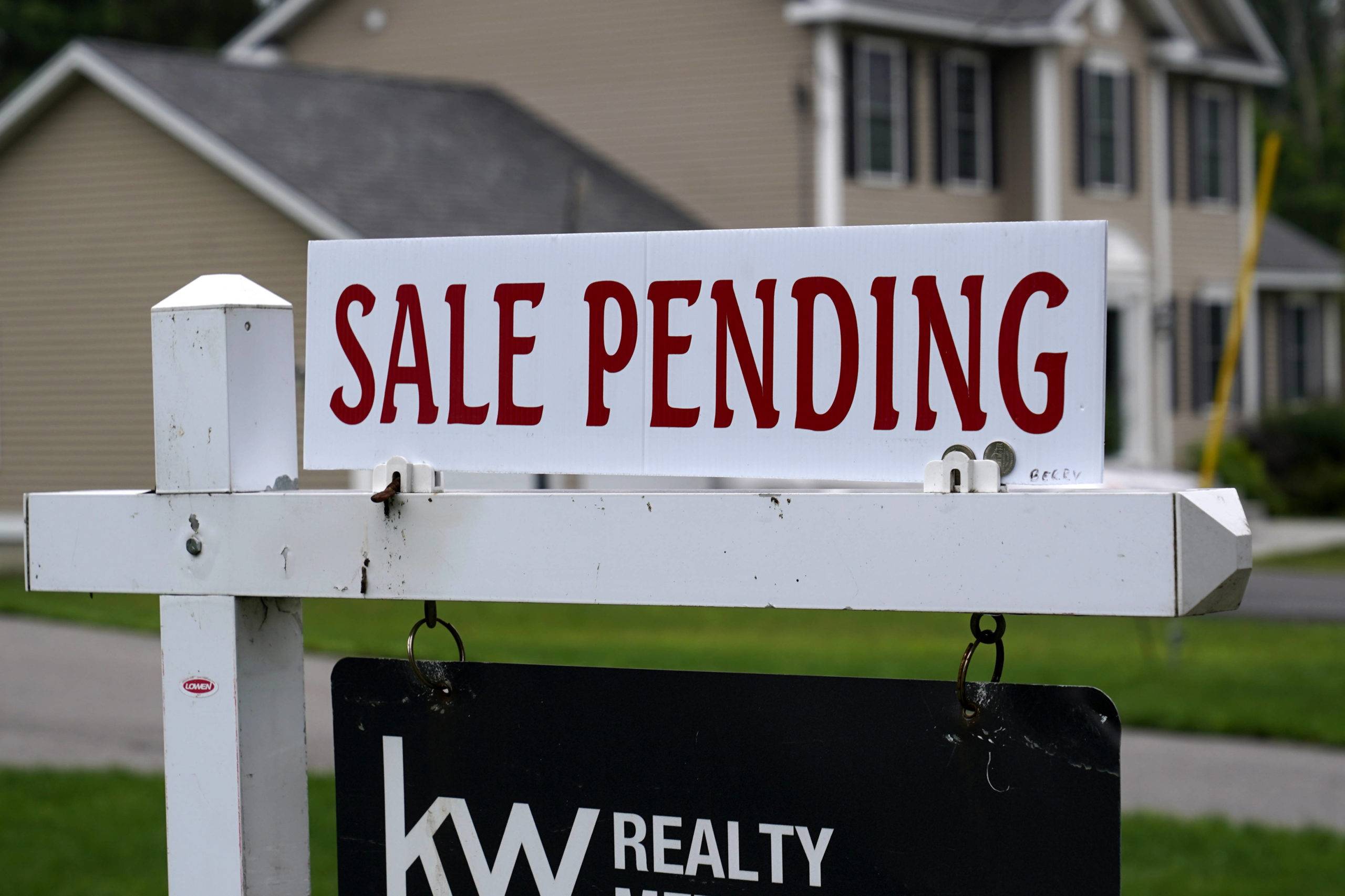 A "sale pending" sign is posted outside a single family home in a residential neighborhood, Wednesday, July 14, 2021, in Derry, N.H. Mortgage rates were mixed this week. The benchmark 30-year loan fell for the third straight week amid lingering concerns over the recent surge in inflation.   (AP Photo/Charles Krupa)/NYBZ510/21196608729891//2107151939