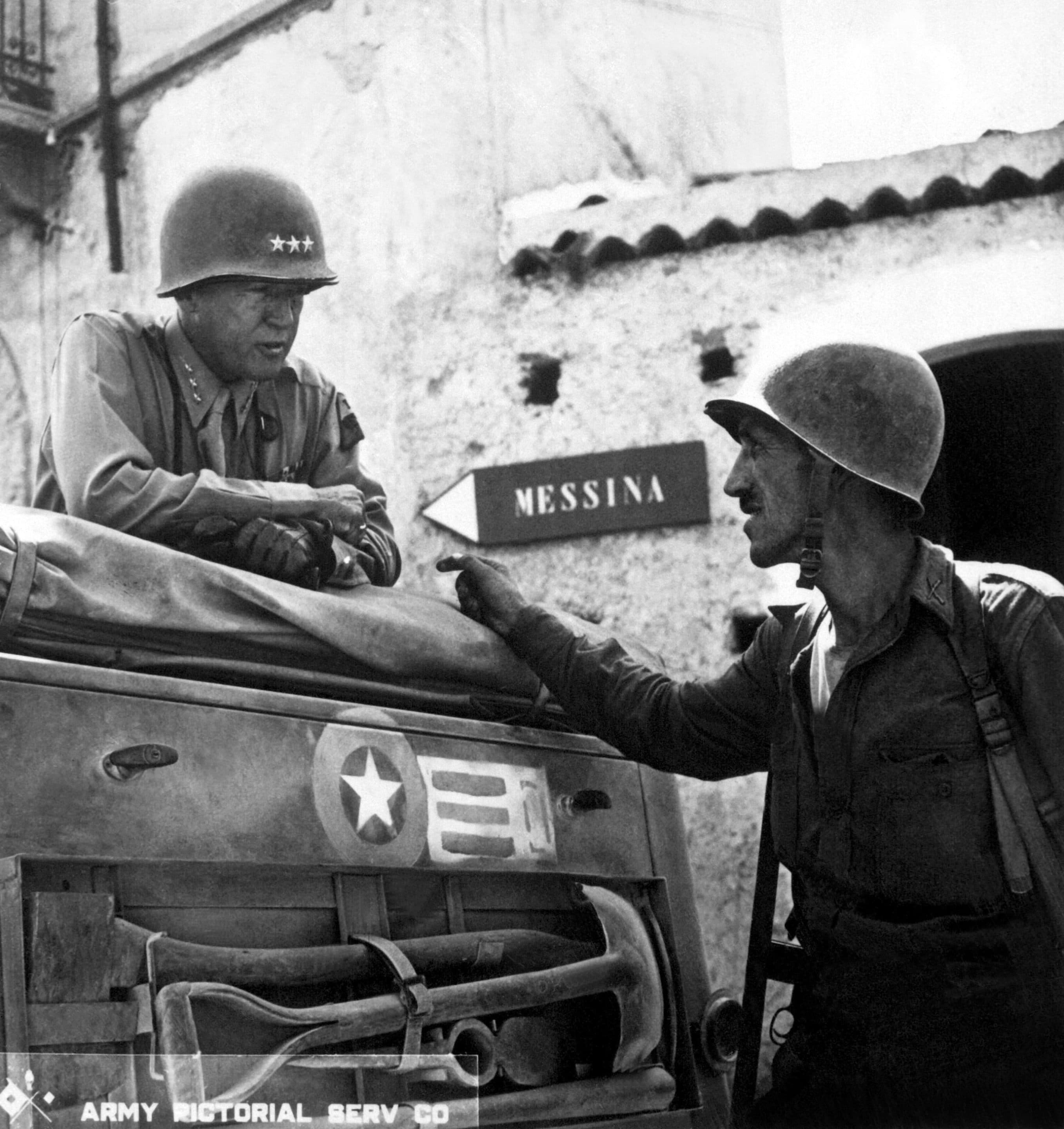 Lt. Col. Lyle Bernard, CO, 30th Inf. Regt., a prominent figure in the second daring amphibious landing behind enemy lines on Sicily's north coast, discusses military strategy with Lt. Gen. George S. Patton.  Near Brolo.  1943.   (Army)
Exact Date Shot Unknown
NARA FILE #:  111-SC-246532
WAR & CONFLICT BOOK #:  1024 Crédits : wikicommons