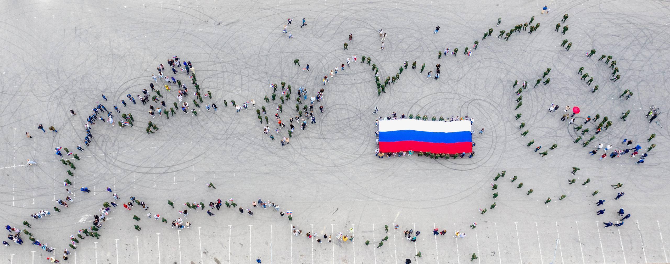 YUZHNO-SAKHALINSK, RUSSIA - JUNE 12, 2021: People gather to form the shape of Russia as it appears on the world map during the #WeRussia flash mob as part of celebrations of Russia Day in Gornolyzhnaya Street. Sergei Krasnoukhov/TASS/Sipa USA/33720645/AK/2106121012