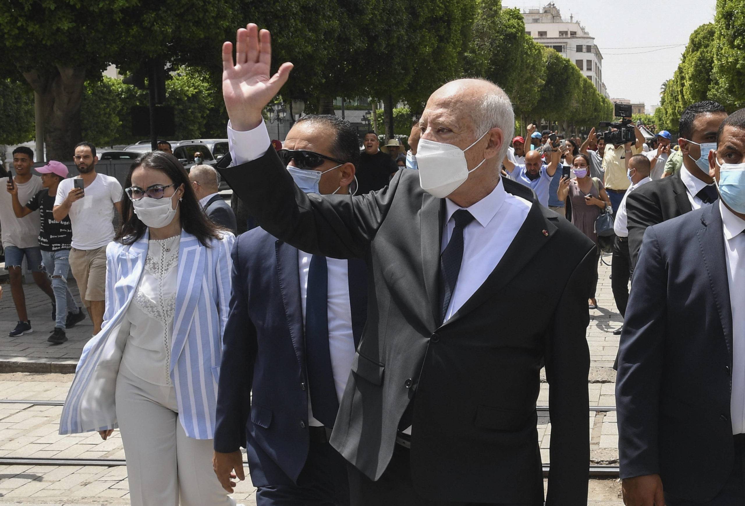 Kais Saied waves to bystanders as he stroll along the avenue Bourguiba in Tunis, Tunisia, Sunday, Aug. 1, 2021. AP)/MEU106/21213691659458/Tunisian Presidency/2108012115