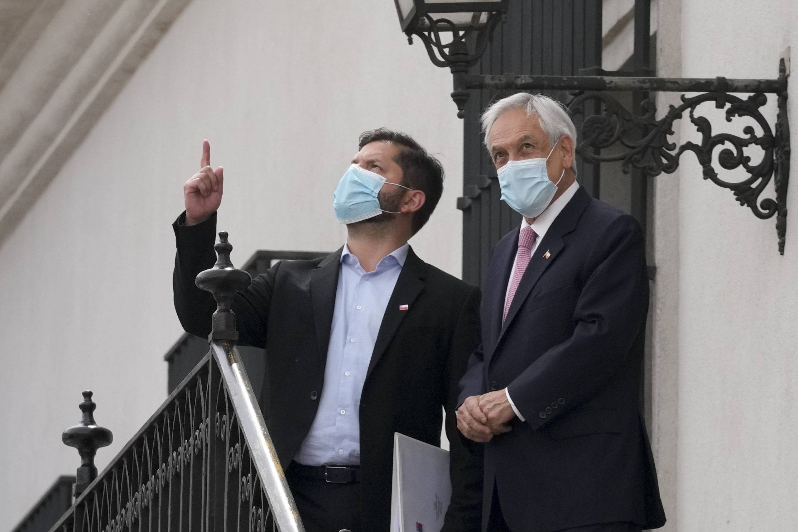 Chilean President-elect Gabriel Boric, left, and current President Sebastian Pinera meet at La Moneda presidential palace in Santiago, Chile, Monday, Dec. 20, 2021. (AP Photo/Esteban Felix)/NAT104/21354691240432//2112202018