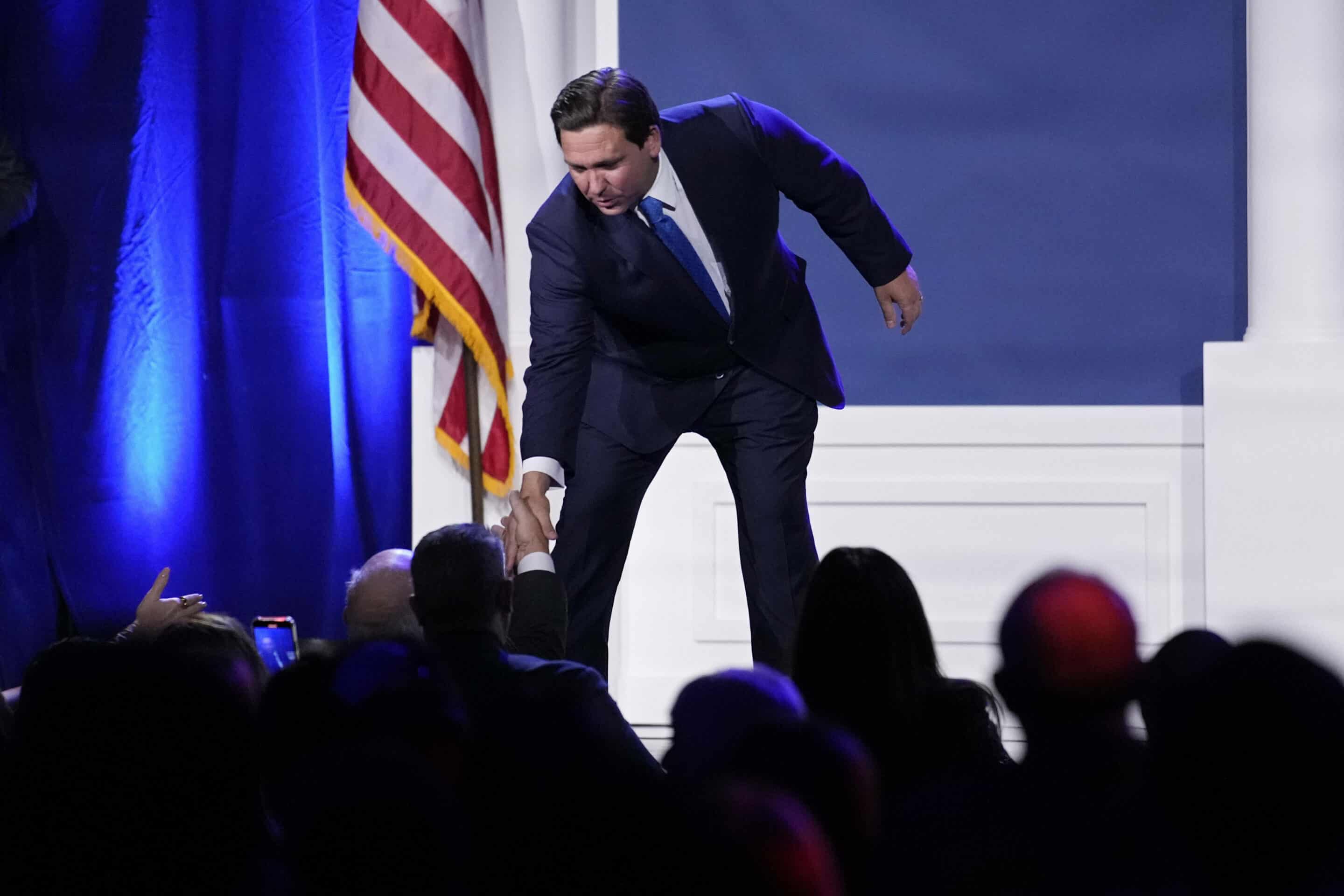 Florida Gov. Ron DeSantis shakes hands with people after speaking at an annual leadership meeting of the Republican Jewish Coalition Saturday, Nov. 19, 2022, in Las Vegas. (AP Photo/John Locher)/NVJL157/22324198039702//2211200640