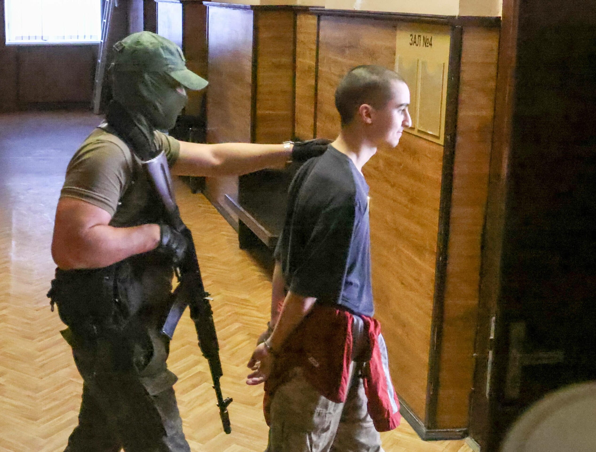 DONETSK, DONETSK PEOPLE'S REPUBLIC - JUNE 9, 2022: Moroccan national Saaudun Brahim (R) who is facing criminal charges in connection with his fighting as a foreign mercenary in the Ukrainian Armed Forces is escorted to a sentencing hearing at the Supreme Court of the Donetsk People's Republic (DPR). The court has sentenced the Moroccan man to death penalty. The DPR Prosecutor-General's Office has stated that the defendant has been found guilty of crimes under three articles of the Criminal Code of the Donetsk People's Republic. Earlier, the DPR Prosecutor-General's Office said that the defendant could face death penalty. Vladimir Gerdo/TASS/Sipa USA/39813412/DF/2206091721