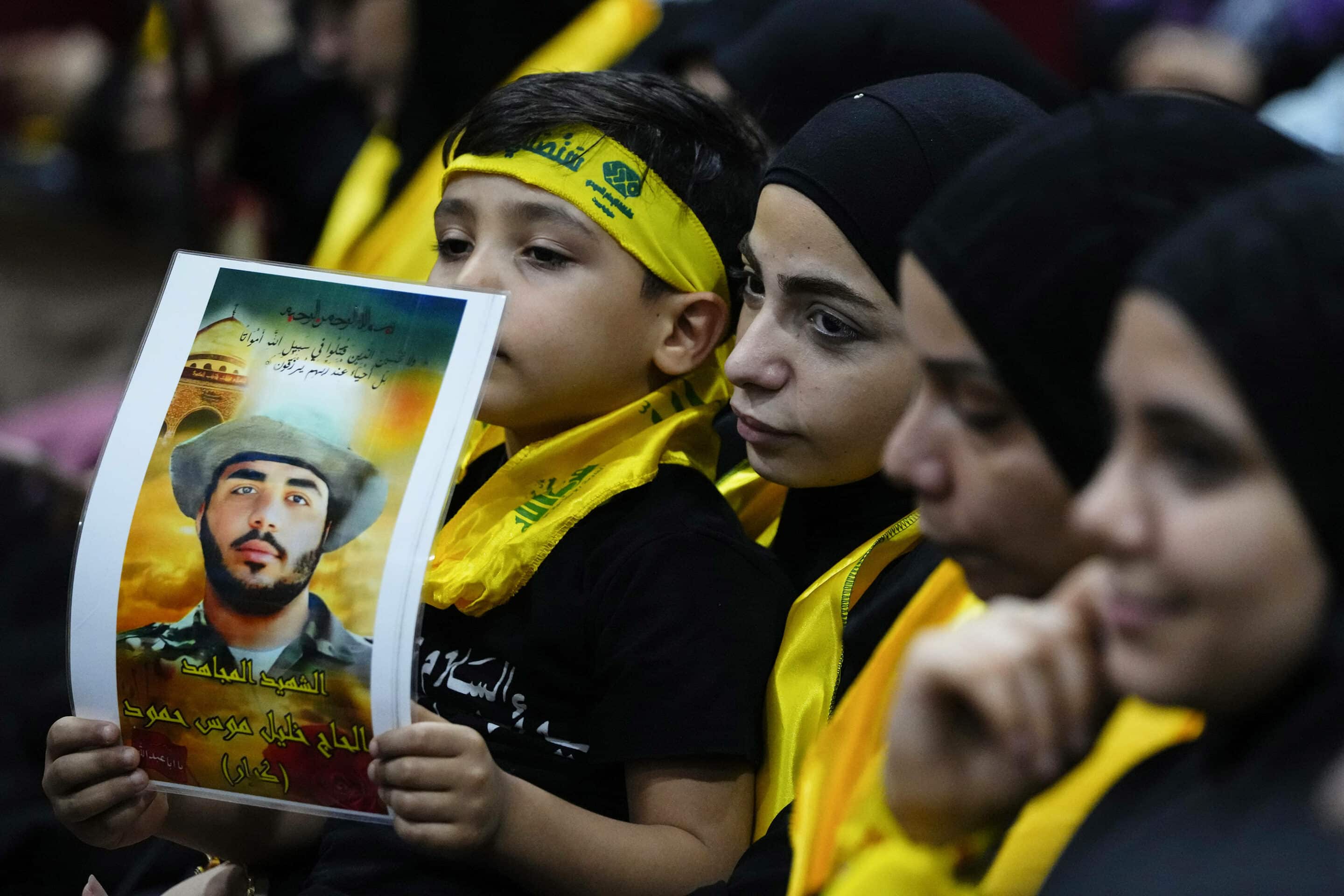 Hezbollah supporters hold pictures of their relatives who died. Southern Beirut suburb of Dahiyeh, Lebanon, Saturday, Nov. 11, 2023. (AP Photo/Hassan Ammar)/HAS116/23315545202509//2311111618